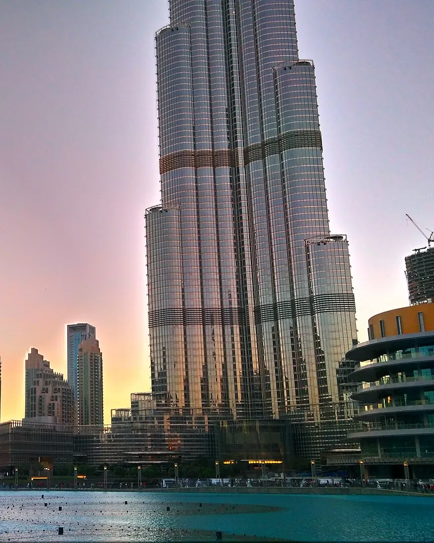 The Burj Khalifa at dusk, above the Dubai Fountain lake